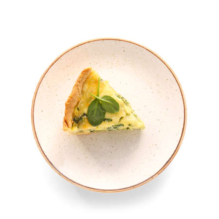 Plate with piece of tasty spinach tart on white backgroundの写真素材