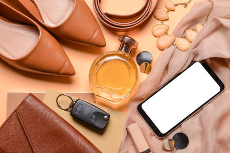 Different female accessories and mobile phone on color backgroundの写真素材