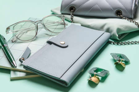 Wallet and different female accessories on color backgroundの写真素材