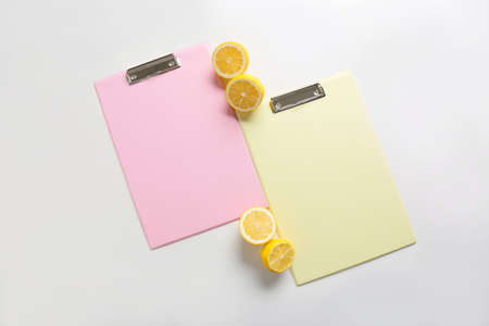 Blank clipboards and lemons on white backgroundの写真素材