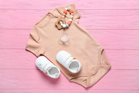 Baby clothes, shoes and accessories on wooden backgroundの写真素材
