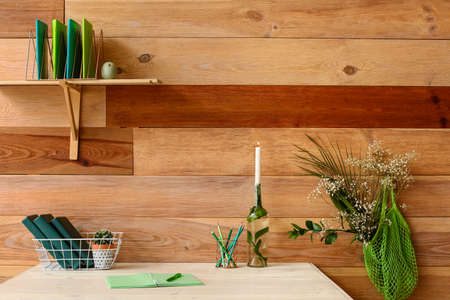 Modern workplace with stationery near wooden wall