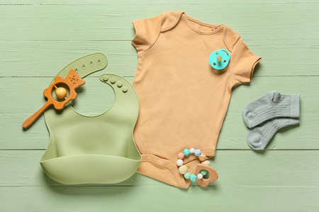 Baby clothes, toys and accessories on color wooden backgroundの写真素材