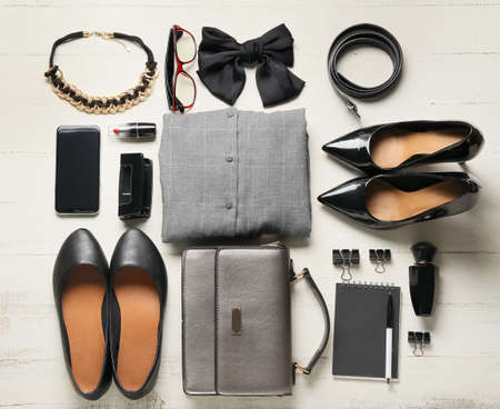Female clothes and accessories on light wooden backgroundの写真素材