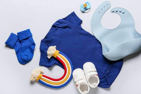 Baby clothes, shoes, toy and accessories on gray backgroundの写真素材