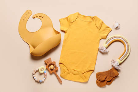 Composition with baby clothes, bib and accessories on color backgroundの写真素材