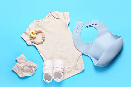 Baby clothes, shoes and accessories on color backgroundの写真素材