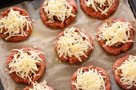 Minced meat boats with mushrooms and grated cheese, closeup