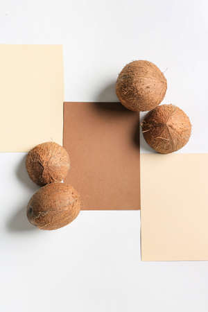 Composition with blank cards and ripe coconuts on white backgroundの写真素材