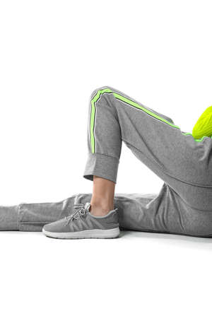 Legs of sporty young woman on white backgroundの写真素材