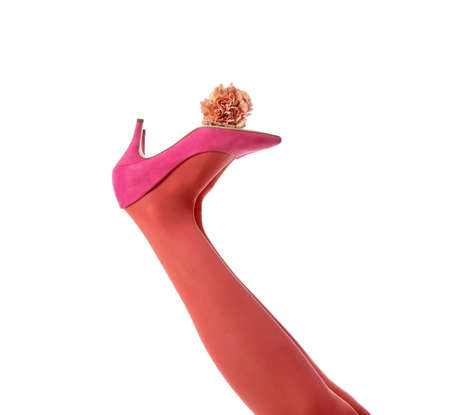 Legs of stylish young woman with flower on white backgroundの写真素材