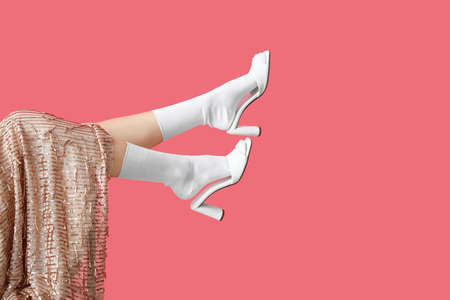 Legs of stylish young woman on color backgroundの写真素材