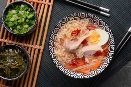 Composition with tasty Chinese soup on dark backgroundの写真素材