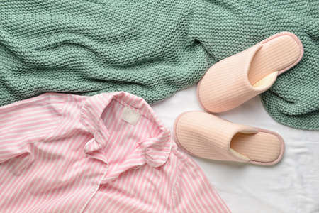 Slippers and pajamas on fabric backgroundの写真素材