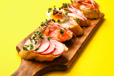 Different bruschettas with micro green on color background, closeupの写真素材