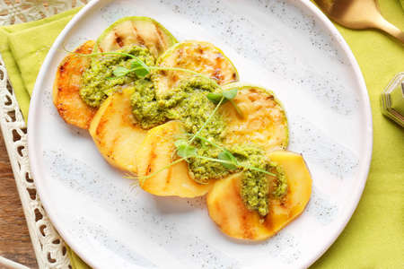 Plate with tasty grilled vegetables with pesto sauce on table, closeupの写真素材
