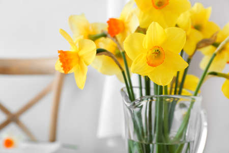 Vase with beautiful daffodils in bathroom, closeupの写真素材