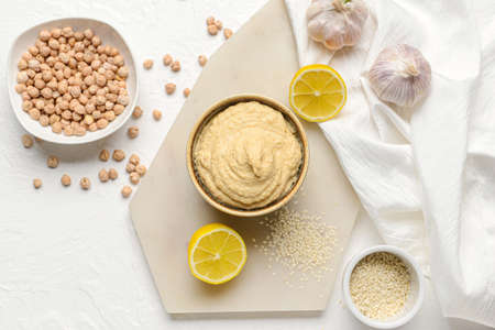 Composition with tasty hummus on light backgroundの写真素材