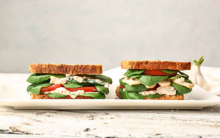 Plate with tasty sandwiches on light backgroundの写真素材