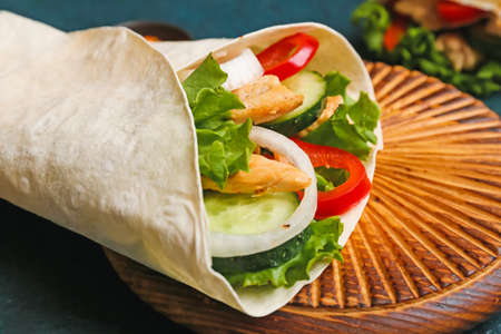 Board with tasty doner kebab on color background, closeupの写真素材