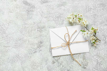 Envelope and beautiful blooming branches on grunge background