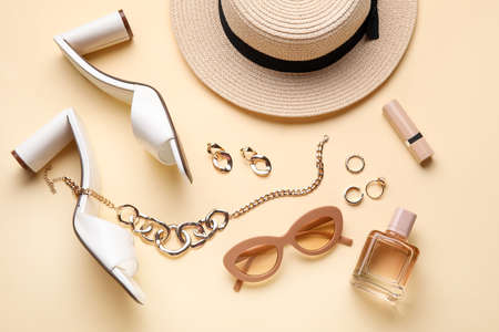Set of female accessories with shoes and cosmetics on color backgroundの写真素材