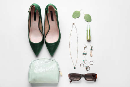 Set of female accessories with shoes and lipstick on white backgroundの写真素材