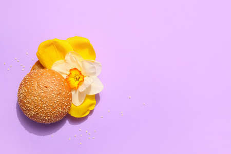 Creative composition with burger and flowers on color backgroundの写真素材