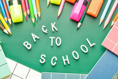 Composition with text BACK TO SCHOOL and stationery on color backgroundの写真素材