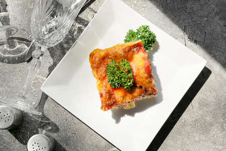 Plate with tasty vegetable lasagna on grunge backgroundの写真素材