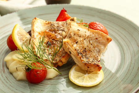 Plate with tasty baked cod fillet, vegetables and mashed potatoes, closeupの写真素材