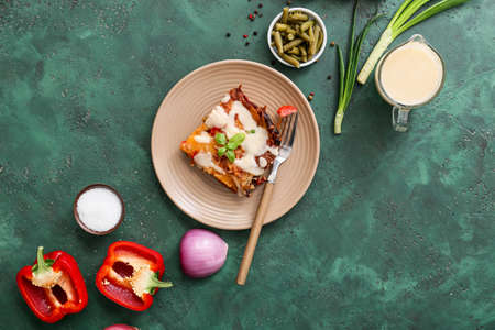 Composition with tasty vegetable lasagna and spices on color background