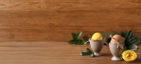Easter eggs on wooden background with space for textの写真素材
