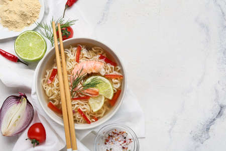 Composition with tasty Thai soup on light backgroundの写真素材