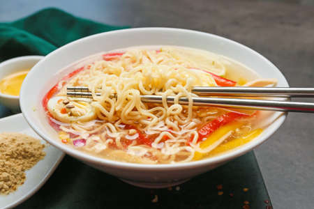 Bowl of tasty Thai soup on dark background, closeupの写真素材