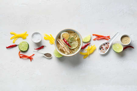 Composition with tasty Thai soup on light backgroundの写真素材