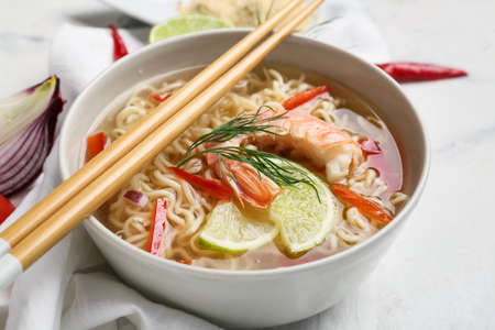 Bowl of tasty Thai soup with shrimps on light background, closeupの写真素材