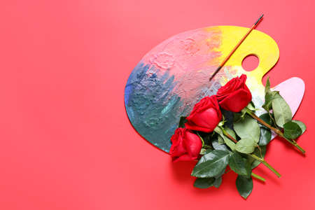 Beautiful roses and palette paint on color backgroundの写真素材