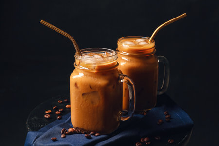 Mason jars of iced coffee on dark backgroundの写真素材