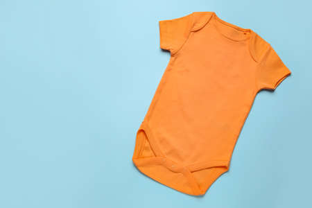Baby clothes on color background