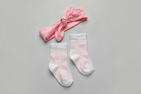 Baby socks and headband on light backgroundの写真素材