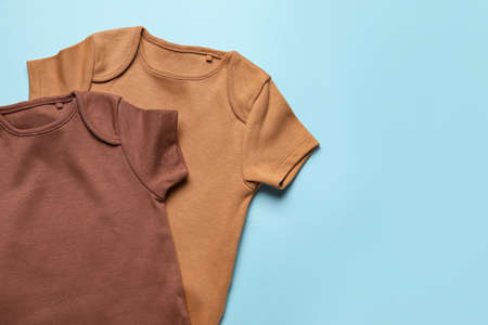 Baby clothes on color backgroundの写真素材