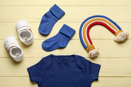Set of baby clothes on color wooden backgroundの写真素材