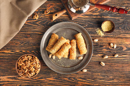 Composition with delicious baklava on wooden background