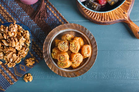 Composition with delicious baklava on color wooden backgroundの写真素材