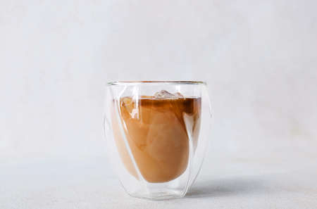 Glass of ice coffee on white background