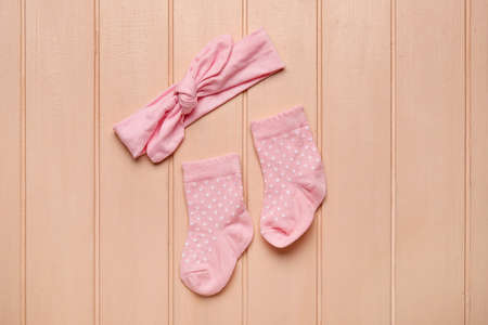 Baby socks and headband on color wooden backgroundの写真素材