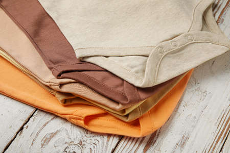 Baby clothes on light wooden background, closeupの写真素材