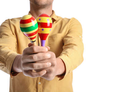 Young mexican man with maracas on white backgroundの写真素材