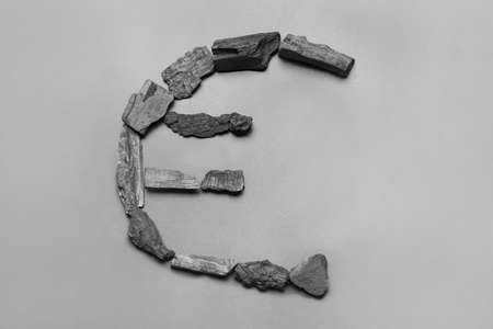 Euro sign made of charcoal on gray background